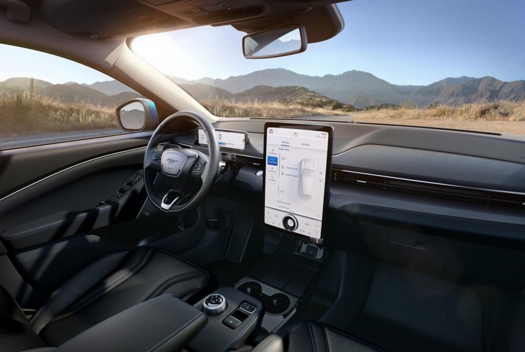 Ford Motor Company Executive Chairman Bill Ford, left, and actor Idris Elba next to Ford Motor Co.’s all-electric Mustang Mach-E GT SUV at Jet Center Los Angeles in Hawthorne, California on Sunday, Nov. 17, 2019. Elba, who previously worked at Ford Motor Co. in the 1980s, helped introduce the vehicle to the public. Launching in late 2020, Mustang Mach-E will be available in several variations, including an extended-range battery and rear-wheel drive option that has a targeted EPA-estimated range of at least 300 miles.