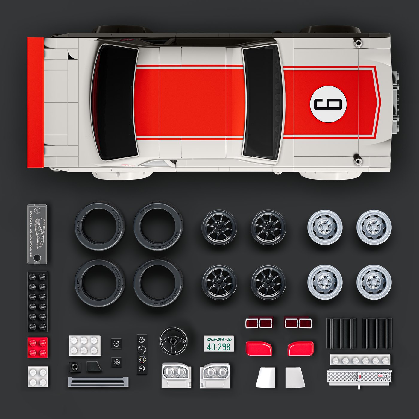 Vue de dessus de la Skyline 2000GT-R Mattel Brick Shop et des pièces fournies : pneus, deux jeux de jantes, plaque signature